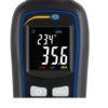 A close-up view of an electronic device displaying a temperature reading of 23.4°C and a noise level of 35.6 dBA. The device has a screen with two readings and buttons labeled "HOLD" and an up arrow symbol. The device's logo, "PCE", is visible at the top.